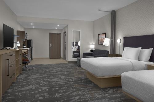 a hotel room with a bed and a television at Home2 Suites By Hilton Big Spring in Big Spring