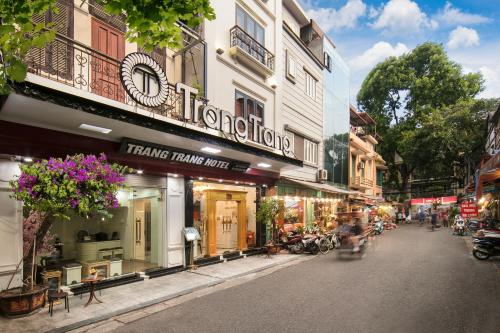 a street with shops on the side of the road at Hanoi TrangTrang Hotel in Hanoi