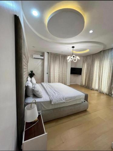 a bedroom with a large bed and a chandelier at Paradise View Apartment in Gatunga