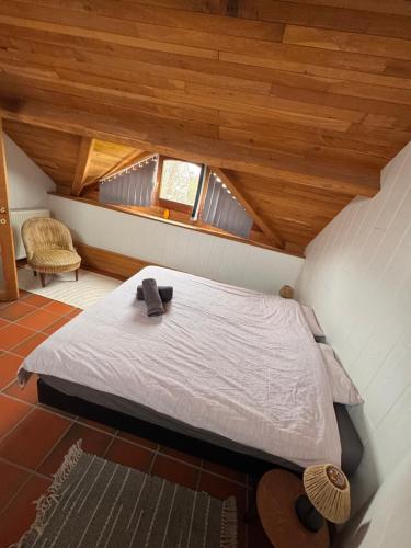 a bedroom with a bed in a room with wooden ceilings at Le Durbuy Lodge in Durbuy