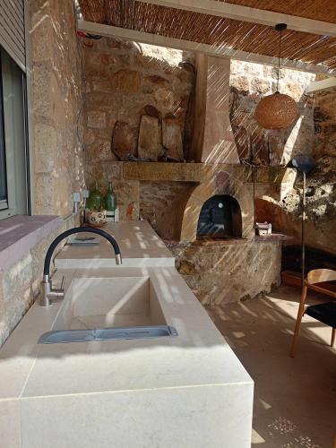 a kitchen with a sink and a stone oven at ALONI retreat in Proástion