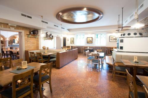 a restaurant with wooden tables and chairs and a cafeteria at Thalinger Hof in Kronstorf