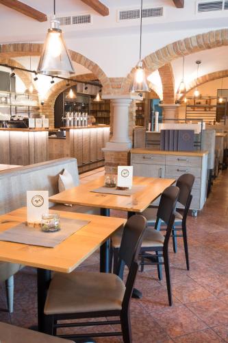 a dining room with wooden tables and chairs at Thalinger Hof in Kronstorf