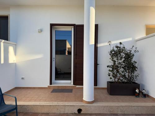 a house with a potted plant on a patio at Dreamhouse - The Apartment in Leverano