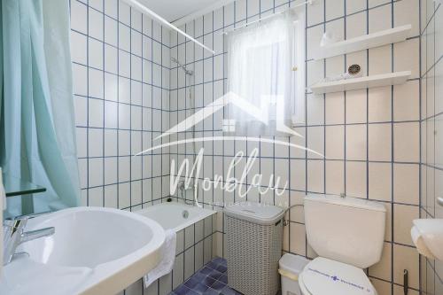 a bathroom with a white toilet and a sink at Sa Torreta 3 in Cala Blanca