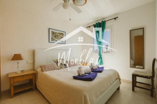 a bedroom with a bed with purple towels on it at Saray Son Alma in Son Carrio