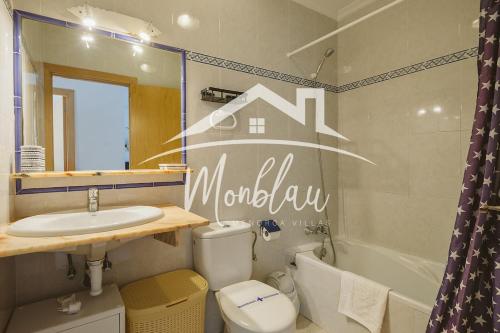 a bathroom with a toilet and a sink and a tub at Saray Son Alma in Son Carrio