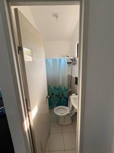 a small bathroom with a toilet and a shower at Blueznest in Babag Island