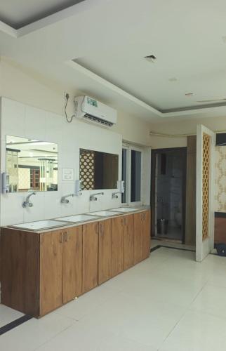 a bathroom with two sinks and a large mirror at CHETAN INN HOTEL in Bhubaneshwar