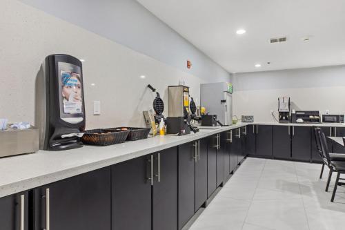 a kitchen with black cabinets and a counter top at Baymont by Wyndham San Antonio Downtown in San Antonio