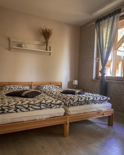 a bedroom with two beds and a window at Rīti Siguldā in Stīveri