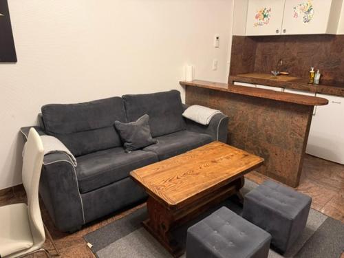 a living room with a couch and a table at Bartholomé LE MAGNIFIQUE in Drancy