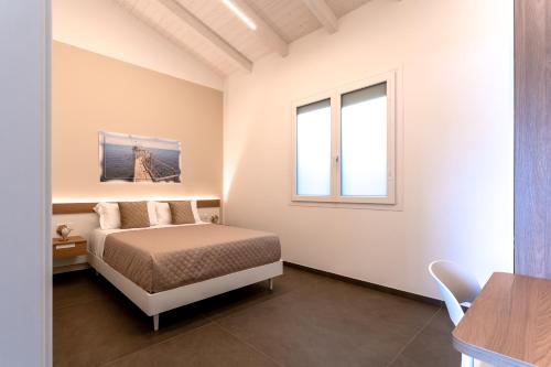 a bedroom with a bed and a table and a window at Mary Pool - Giada in San Vito Chietino