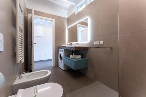a bathroom with a sink and a toilet and a mirror at Mary Pool - Giada in San Vito Chietino