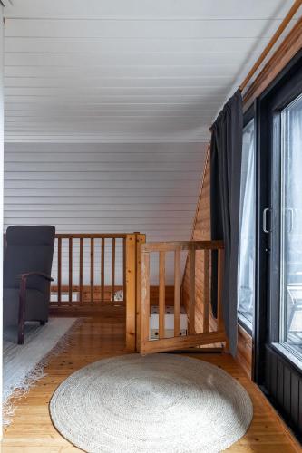 a room with a crib and a large window at Himos Mökki in Jämsä