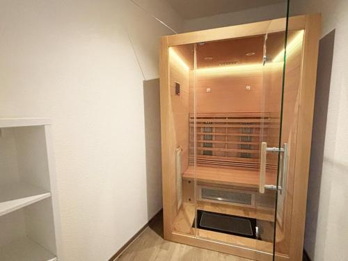 a glass shower in a room with a wall at Ostseeblick-Bollwark Whg 9 in Olpenitz
