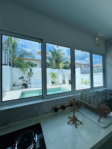 a living room with four windows and a couch at Bayu Senja in Lahad Datu