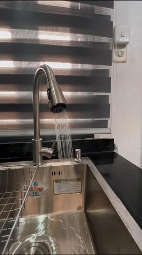 a kitchen sink with water coming out of a faucet at Luxury Homes in Lagos