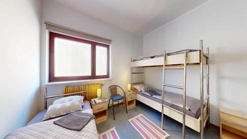 a bedroom with two bunk beds and a window at Willa Mercedes in Gorzów Wielkopolski