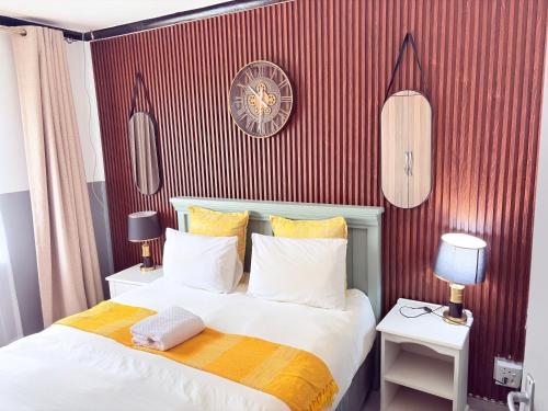 a bedroom with a large bed with red stripes at 38 stay in eMalahleni