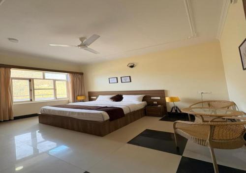 a bedroom with a large bed and a window at SHR Resort in Rudraprayāg