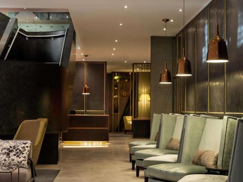 a waiting room with a row of chairs and a hair salon at Sofitel Wellington in Wellington