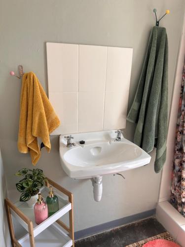 a bathroom with a sink and a mirror at Maltahöhe Self Catering in Maltahöhe