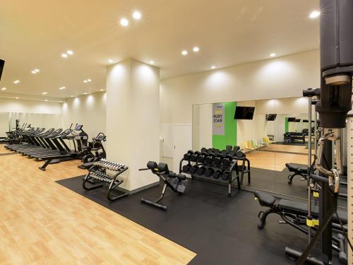 a gym with rows of treadmills and machines at Ibis Styles Sapporo in Sapporo