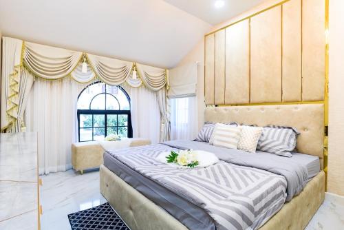 a bedroom with a large bed and a large window at Marina Villa, North Pattaya in North Pattaya