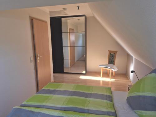 a bedroom with a staircase with a bed and a mirror at Alter Kräutergarten in Dabel