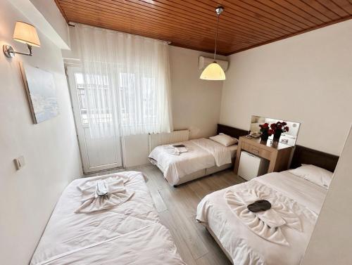 a bedroom with two beds and a window at Efendi Hotel old town special category in Istanbul