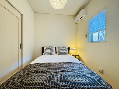 a bedroom with a bed with two pillows at 晴川-箱根Hotel-KA0575 in Sengokuhara