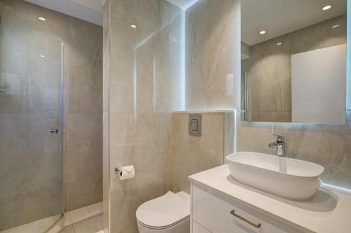a bathroom with a sink and a toilet and a shower at Modern Apartment U2 - Zias with lovely views in heart of Aphrodite Hills in Kouklia