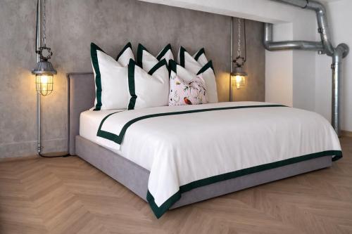 a bedroom with a large white bed with four pillows at Chaya Niwas Loft in Żyrardów