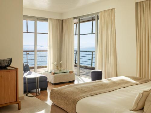 a bedroom with a bed and a view of the ocean at Daios Luxury Living in Thessaloniki