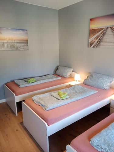 three beds sitting in a room with at Flensburg City 6 1 in Flensburg
