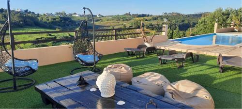 a table with a vase sitting on top of a yard at Terra Luso in Cadaval