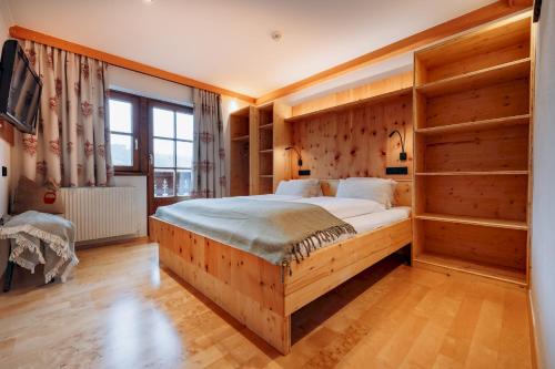 a bedroom with a large bed with wooden shelves at HOFERHOF Schladming -Dachstein in Schladming