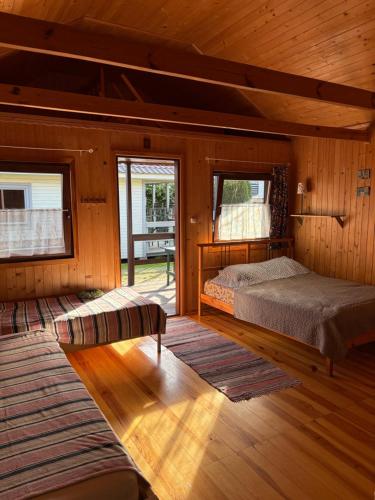 a bedroom with a bed in a wooden cabin at U Franka in Jastarnia