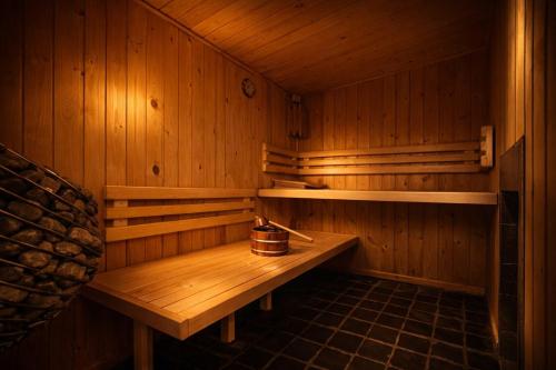 a wooden sauna with a wooden bench in it at Wellness Tuin - Boudoir Suite - Ultieme Partner Beleving - Indoor Jacuzzi en Openhaard en privé Sauna - in Romantische stijl - Gratis Fles Prosecco & Leuke Partner connect box ! in Horst