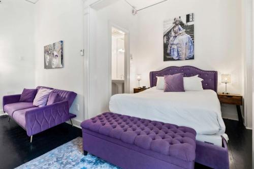 a bedroom with a large bed and a purple couch at Roami at St. Helene in New Orleans