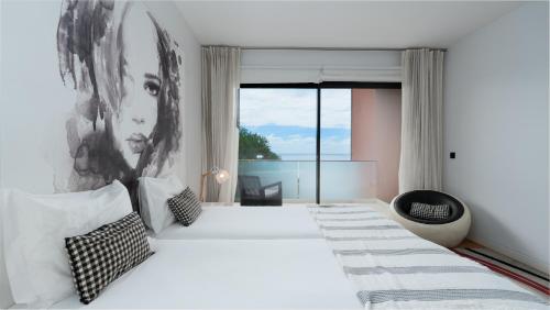 a bedroom with a large bed with a large window at Villa Vitoria - by LovelyStay in Funchal