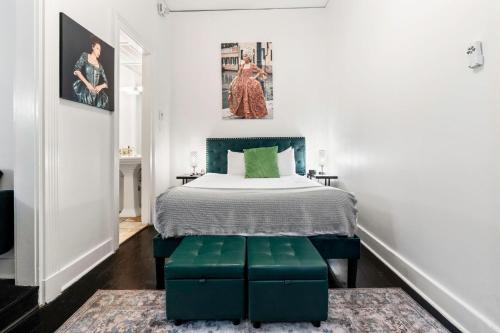 a bedroom with a bed with green ottoman in it at Roami at St. Helene in New Orleans