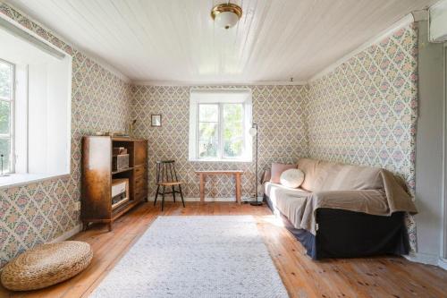 a living room with a couch and a window at Charming Farmhouse in Gammelbo