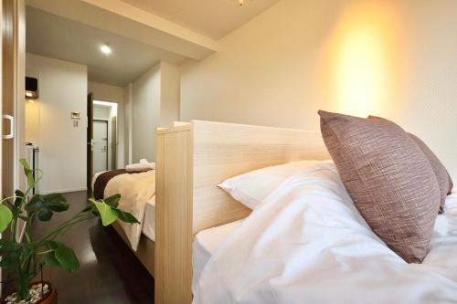 a bedroom with a bed with a pillow on it at Kyo-wa Hotel Oshiage in Tokyo