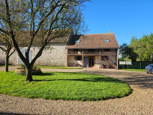 a house with a tree in front of it at Nid de Coucou in Cernoy-en-Berry