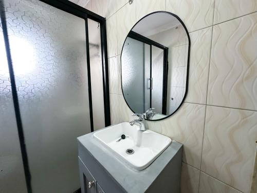 a bathroom with a sink and a mirror at The Residence in Lilongwe
