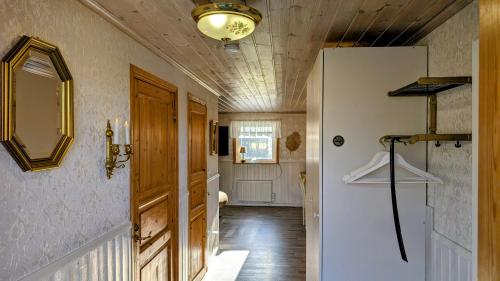 a hallway with a door and a ceiling with a light at Stor älg in Dalskog