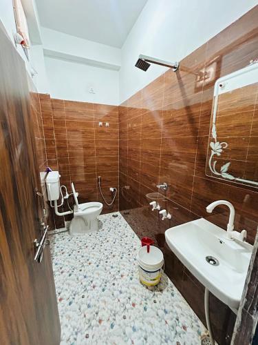 a bathroom with a toilet and a sink at Skyline Hotel & Banquet in Rewa