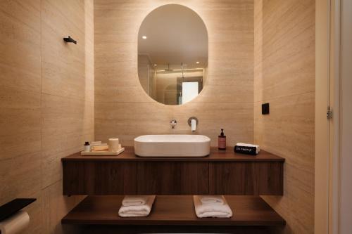 a bathroom with a sink and a mirror at Little Crab Suites in Agios Gordios